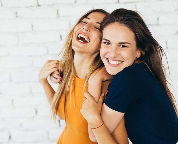two female friends laughing together