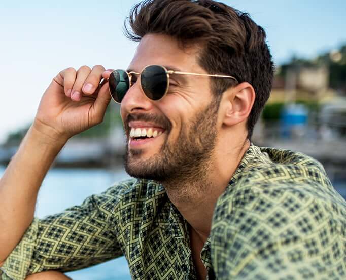 smiling man wearing sunglasses