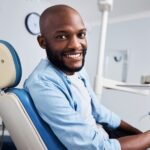 man in dental chair at holistic dentist for whole health dental care