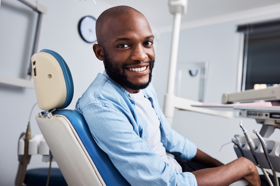 man in dental chair at holistic dentist for whole health dental care