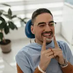 man holding clear aligners, Invisalign can be a holistic way to straighten teeth