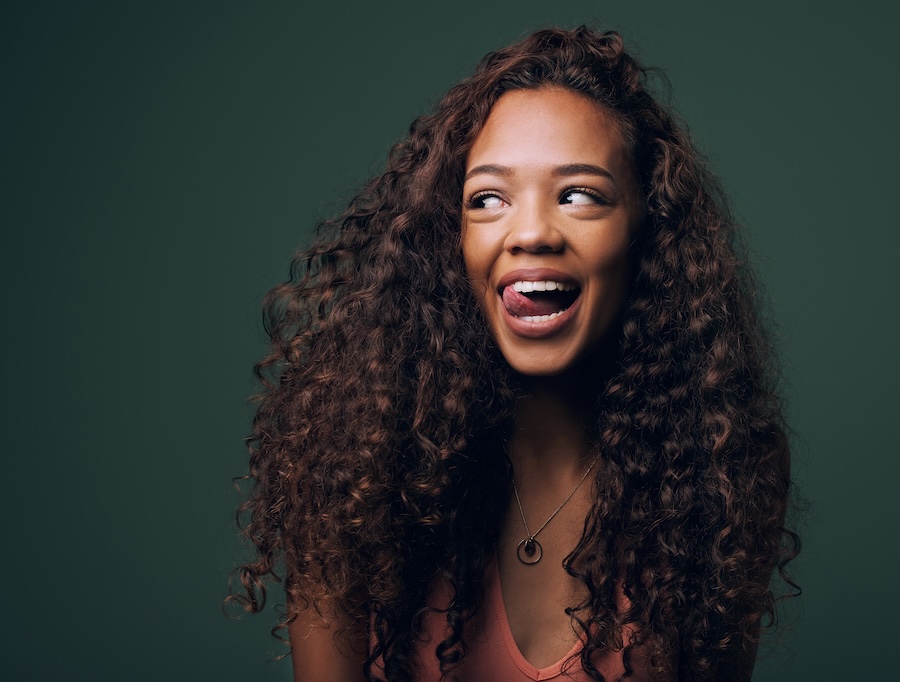 woman smiling with tongue sticking out, tongue posture and jaw tension
